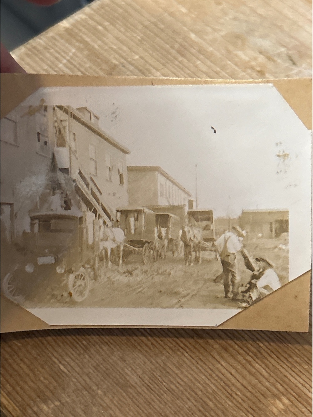 Old picture of a town and buggies and horses